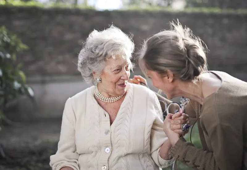 Family member checking in on elderly loved one in the garden