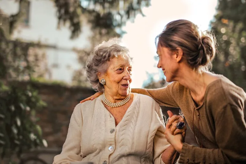 Carer keeping an elderly woman company in her own home as she ages in place