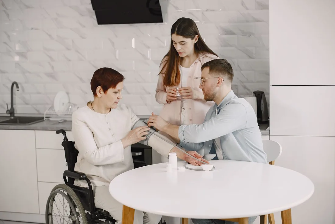 A care worker sitting with an older person during a home visit